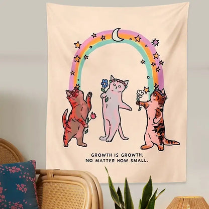 Beige boho cat tapestry wall hanging featuring three illustrated cats with floral crowns and rainbow arch decorbites cat tapestry