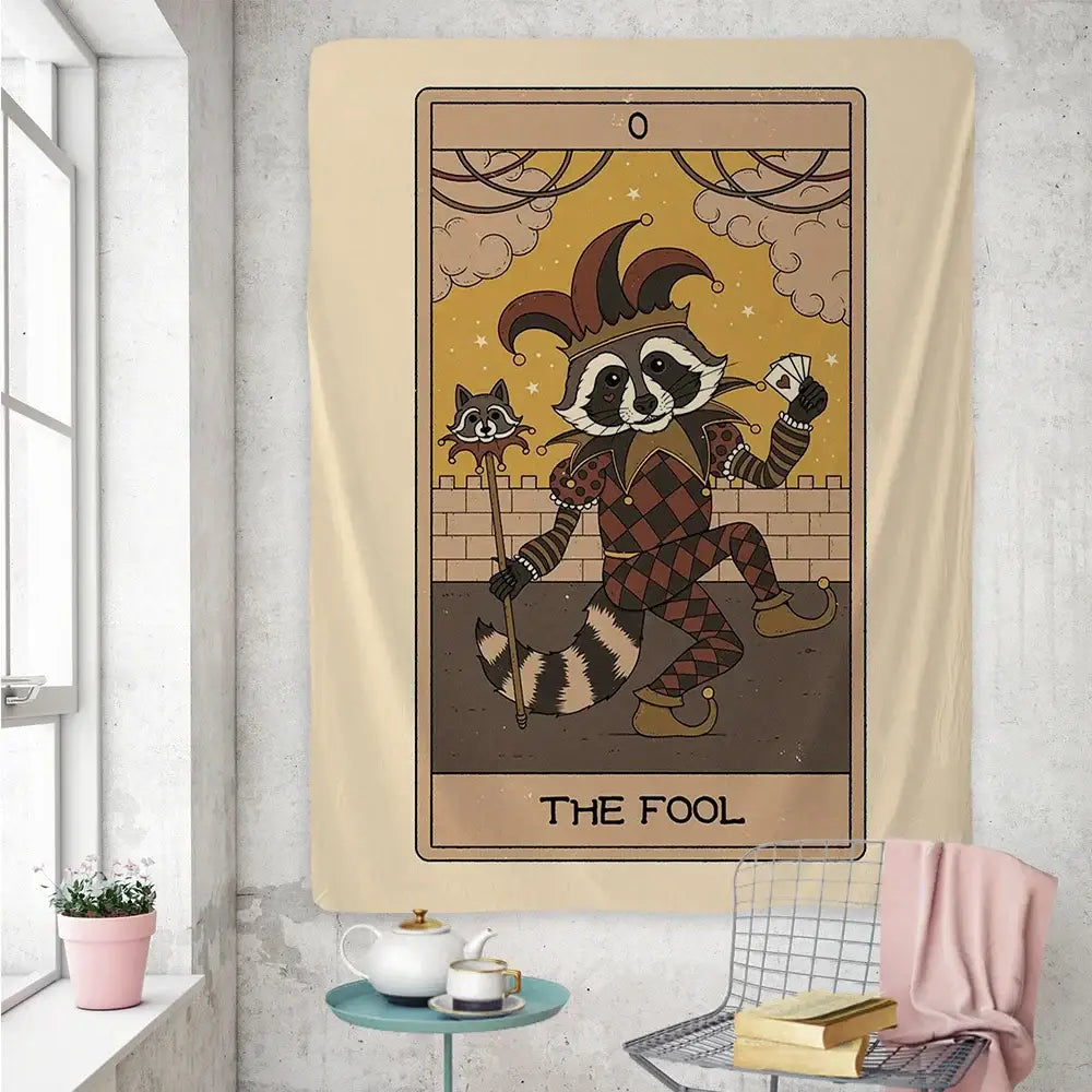 Beige boho tapestry featuring a cute raccoon tarot card dressed as a jester labeled the fool for bedroom wall art