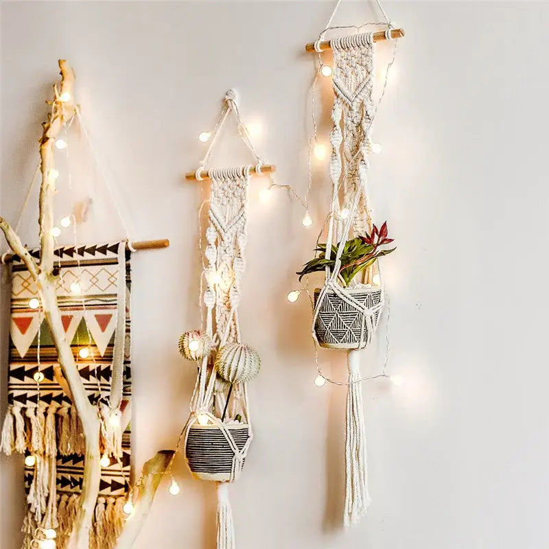 Boho beige macrame plant hanger basket wall art with white macrame and black and white woven pots in geometric patterns