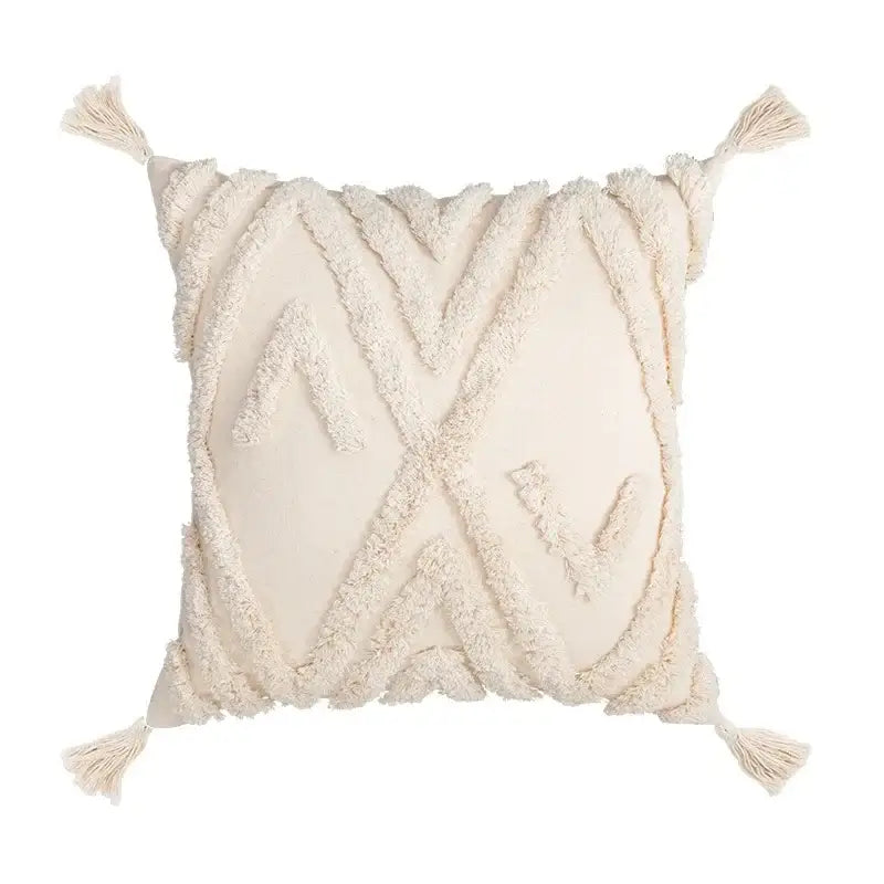 Cream-colored woven cushion cover with textured geometric patterns and tassels in decorbites beige boho style