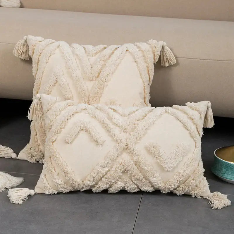 Cream-colored textured cushion cover with geometric embroidery and tassels for decorbites beige boho style decor