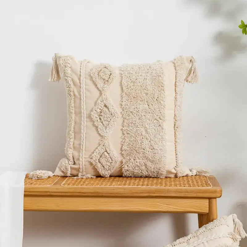 Cream-colored cushion cover with textured woven patterns and tassels in decorbites beige boho style for living room decor