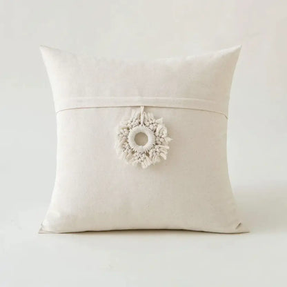 Off-white canvas cushion cover with beige tufted fringed design and delicate macrame wreath pendant decorbites beige tufted