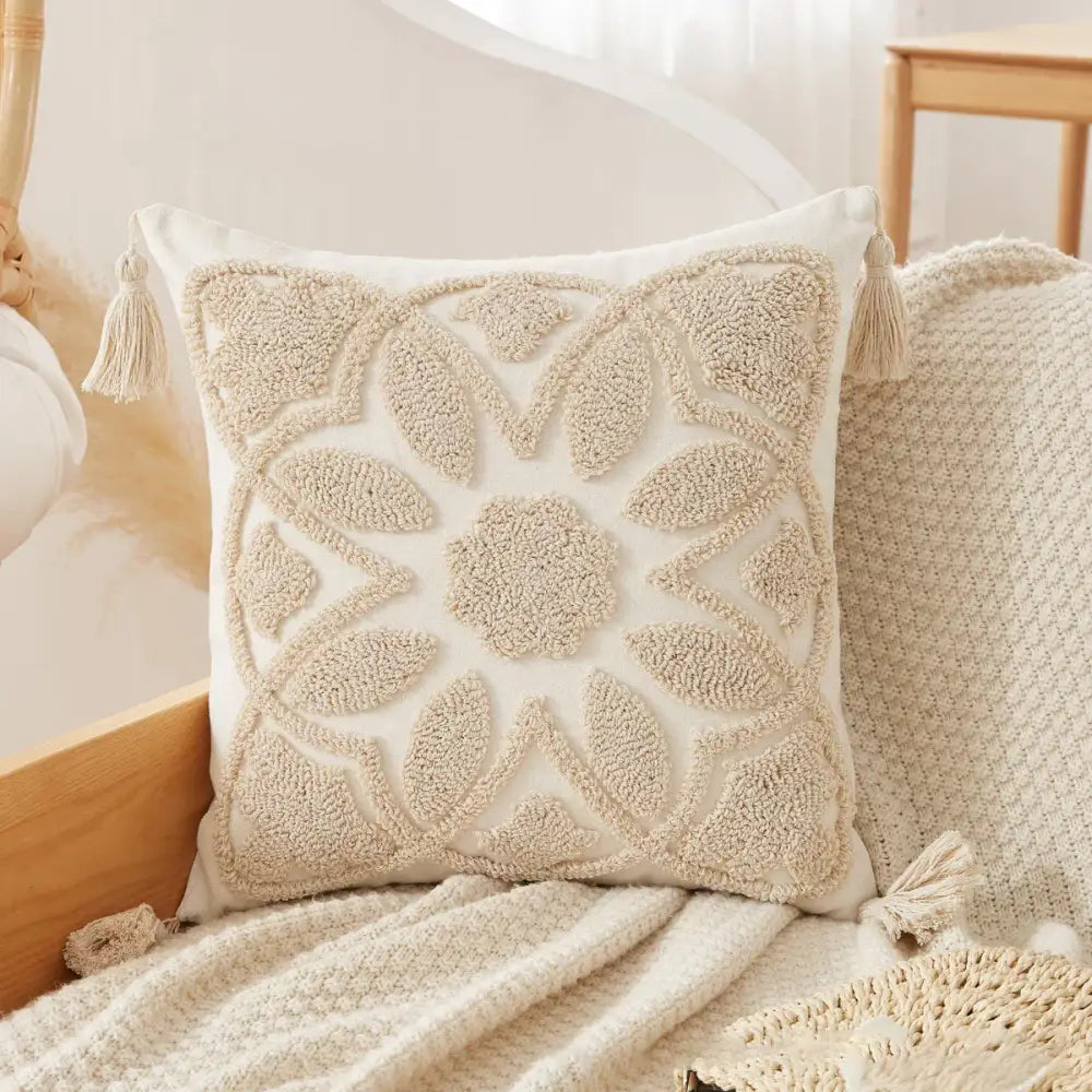 Cream-colored throw pillow with textured embroidered leaf pattern and tassels for decorbites boho beige white pillow cases