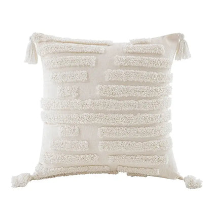 Cream-colored boho beige white tufted tassel pillow cover with textured horizontal stripes and corner fringe tassels for decorbites