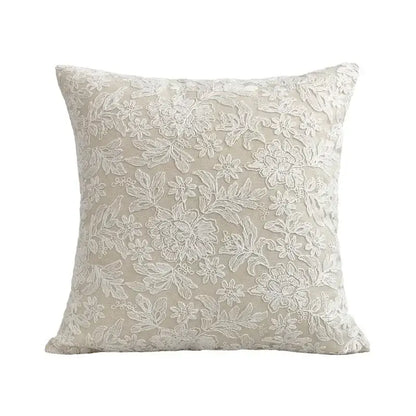Beige square pillow cover with intricate white floral embroidery made of linen cotton for boho living room decor