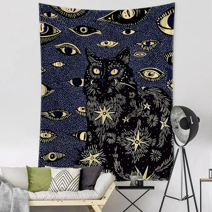 Boho black and gold cat eyes tapestry featuring a central cat with eyes stars and celestial decorbites cat eyes design