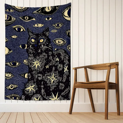 A dark blue boho cat eyes tapestry with a black cat, glowing yellow eyes, and gold celestial wall decor