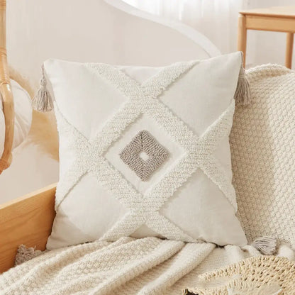 Cream-colored tufted tassel cushion cover with textured white fabric and gray diamond accent for living room use