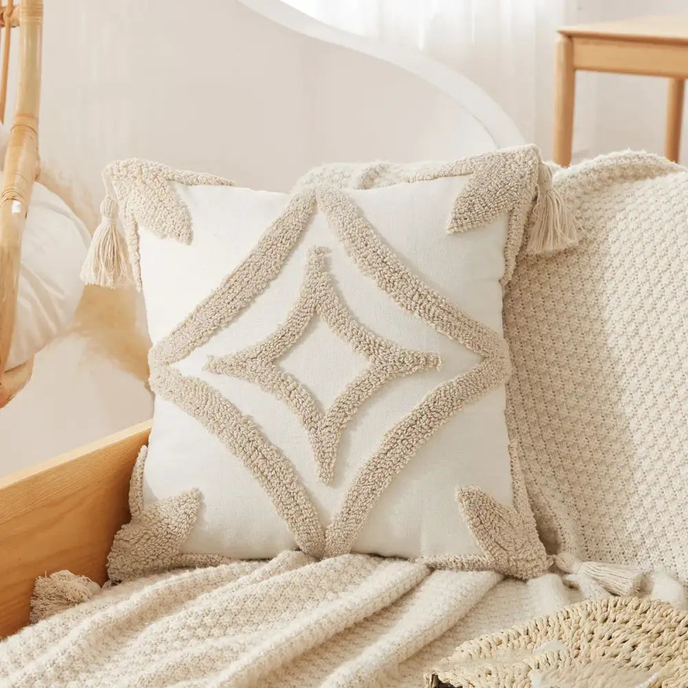 Cream-colored cushion cover with beige geometric embroidery and tassels for a boho tufted tassel cushion cover