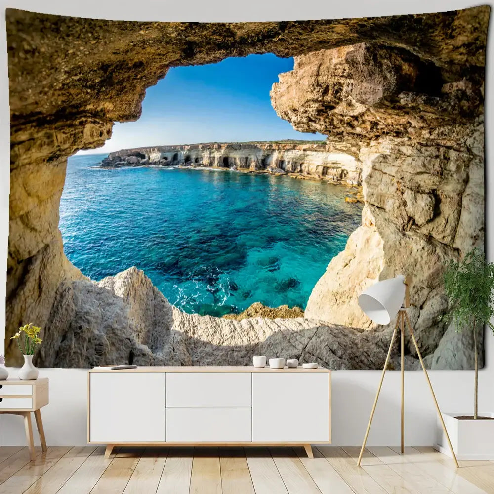 Bohobites coastal cave tapestry wall hanging featuring a vibrant turquoise ocean viewed through natural stone cave archway