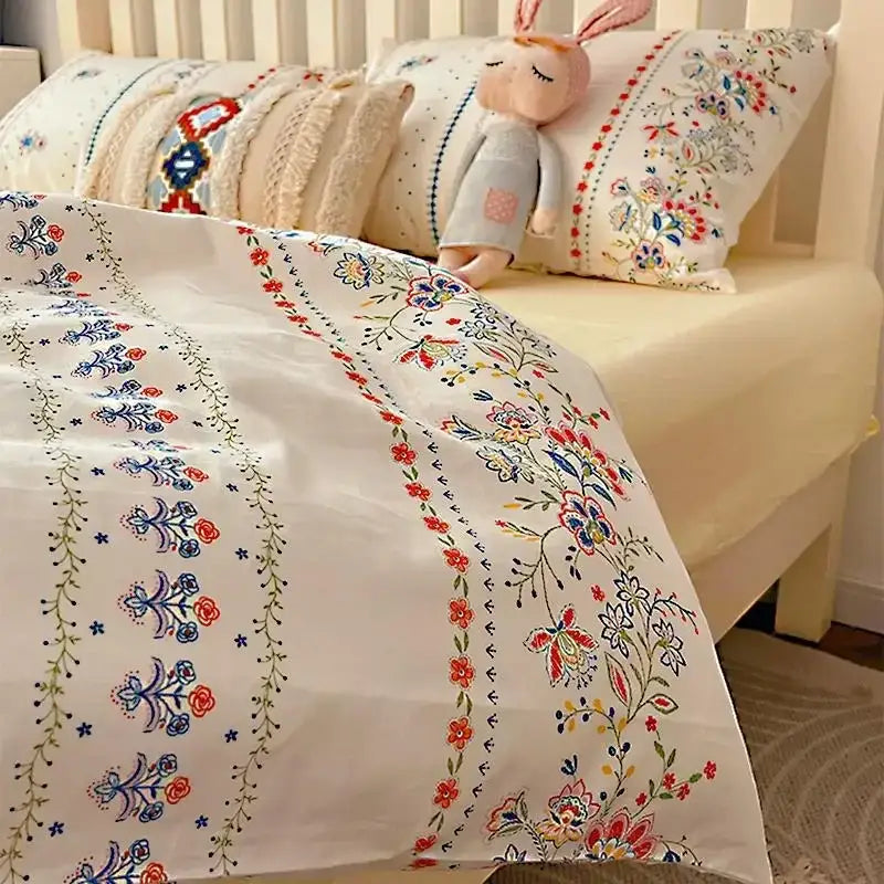 White boho cotton printed duvet cover with intricate red blue and green floral embroidery in decorbites bedding set