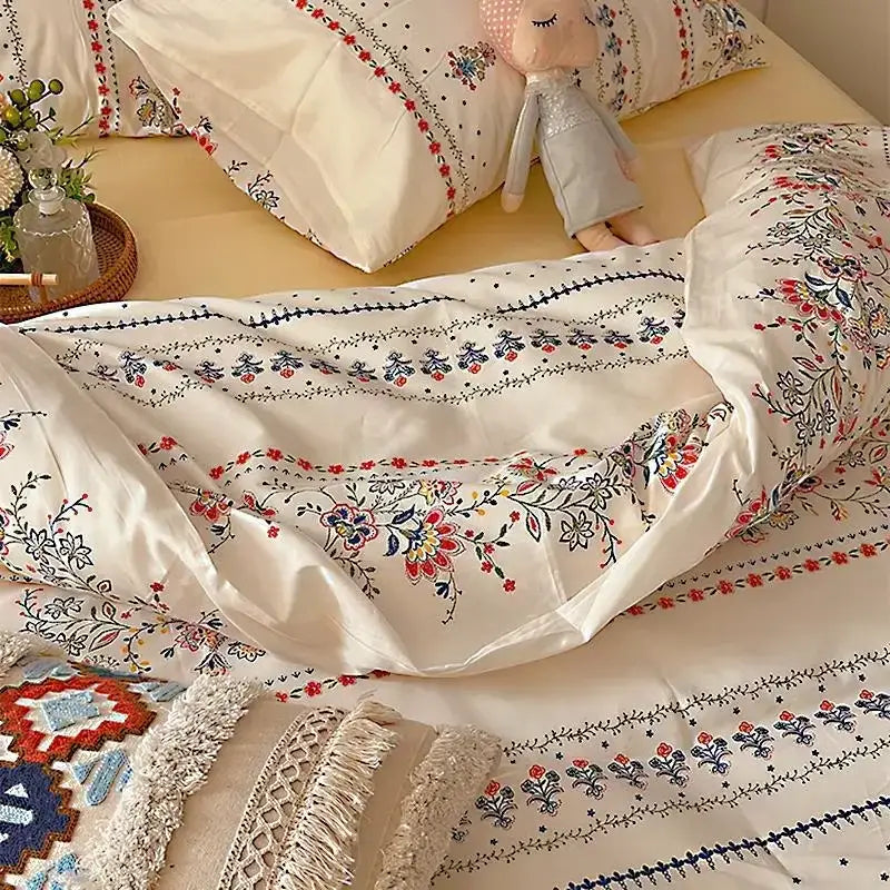 Cream-colored satin duvet cover with intricate red blue and black floral embroidery in decorbites boho cotton printed bedding set