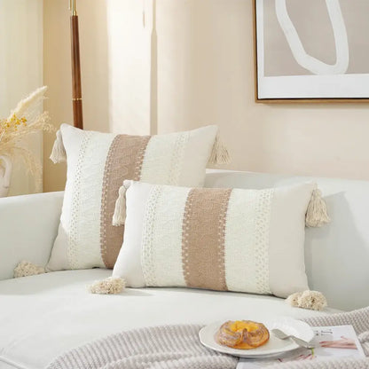 Cream-colored rectangular woven cushion cover with beige stripes and tassel accents for boho living room decor