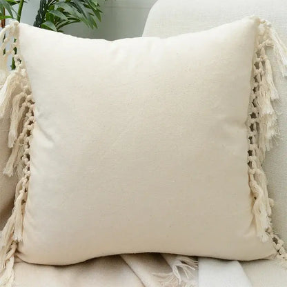 Cream-colored cotton cushion cover with lace floral design and macrame tassels for decorbites boho white style decor