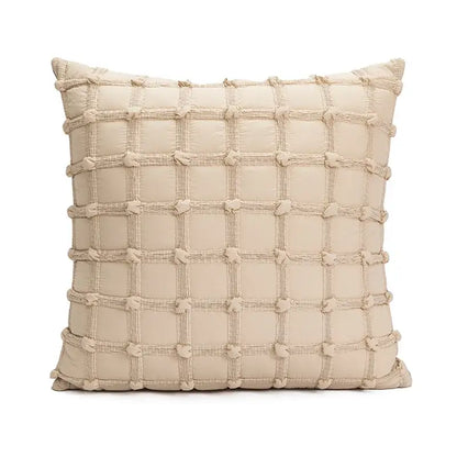 Beige quilted cushion cover with tufted fringe and textured grid pattern woven with cords for living room decor