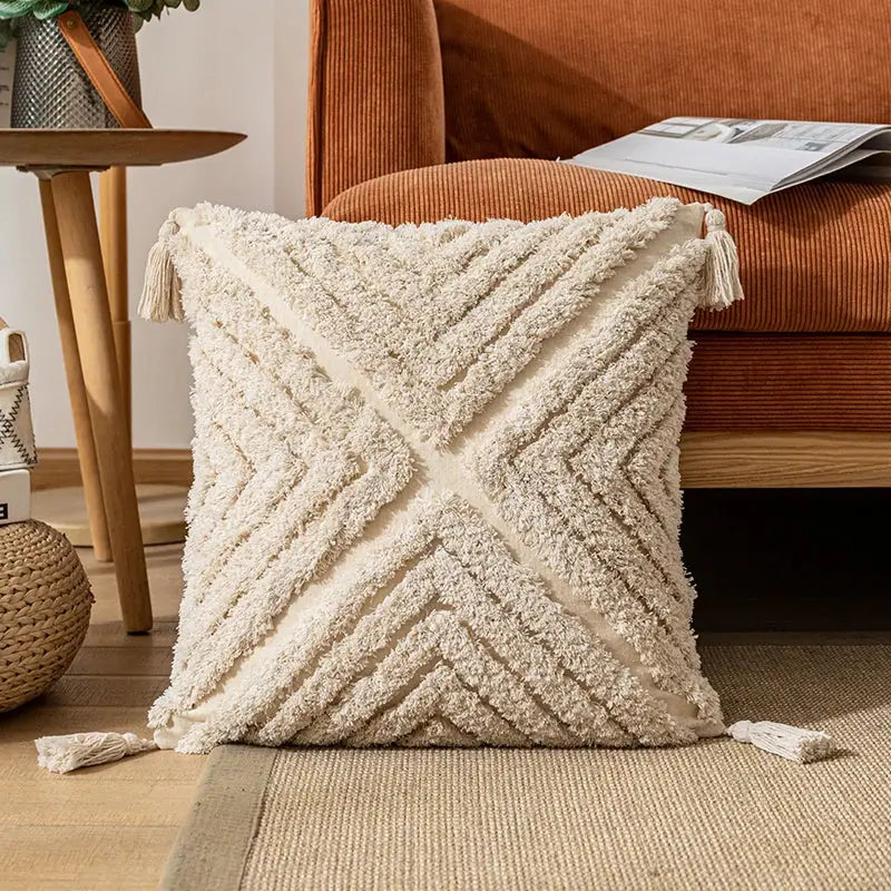 Cream-colored textured cotton pillow cover with geometric v-shaped pattern and tassels for decorbites boho cotton tassel decor
