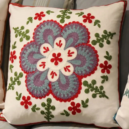 A cream-colored flower elephant pillowcase with vibrant embroidered ethnic flower design in pink and teal decorbites style