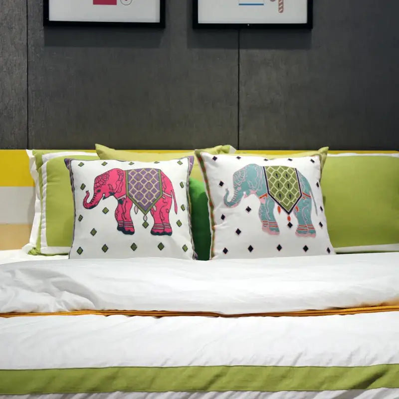 Two decorative boho ethnic flower elephant throw pillows in pink and teal with embroidered flower elephant pillowcase decorbites ethnic flower