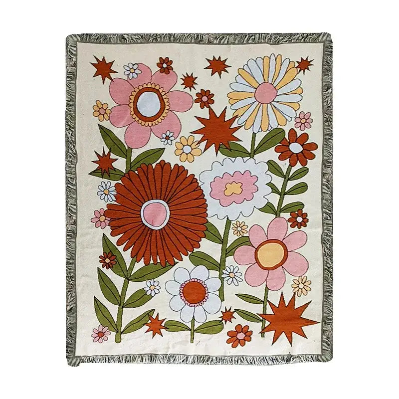 A cream-colored boho floral cotton blanket with vibrant retro blossoms and green leaves for decorbites boho floral throw
