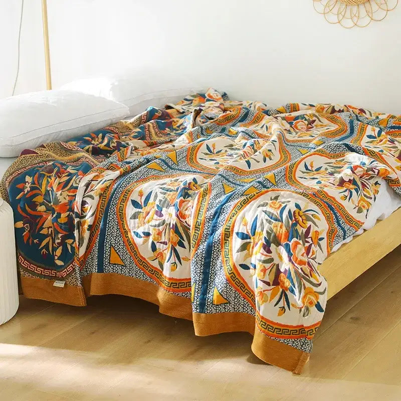A vibrant boho floral cotton gauze leisure blanket with orange blue white and mustard yellow patterns for bedroom decorbites cotton gauze