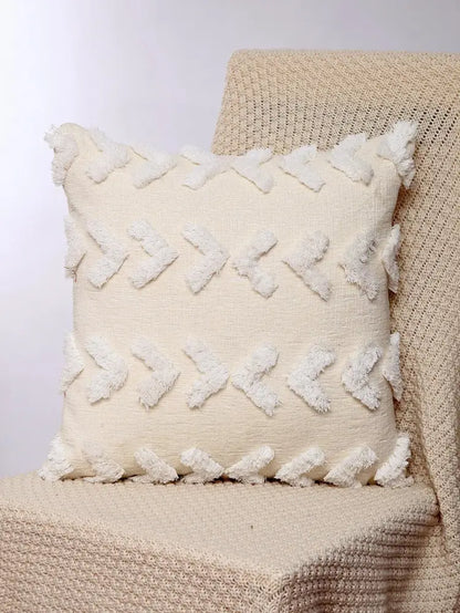 Cream-colored boho geometric chenille embroidered pillow covers with textured fabric and white tassel accents for living room decor