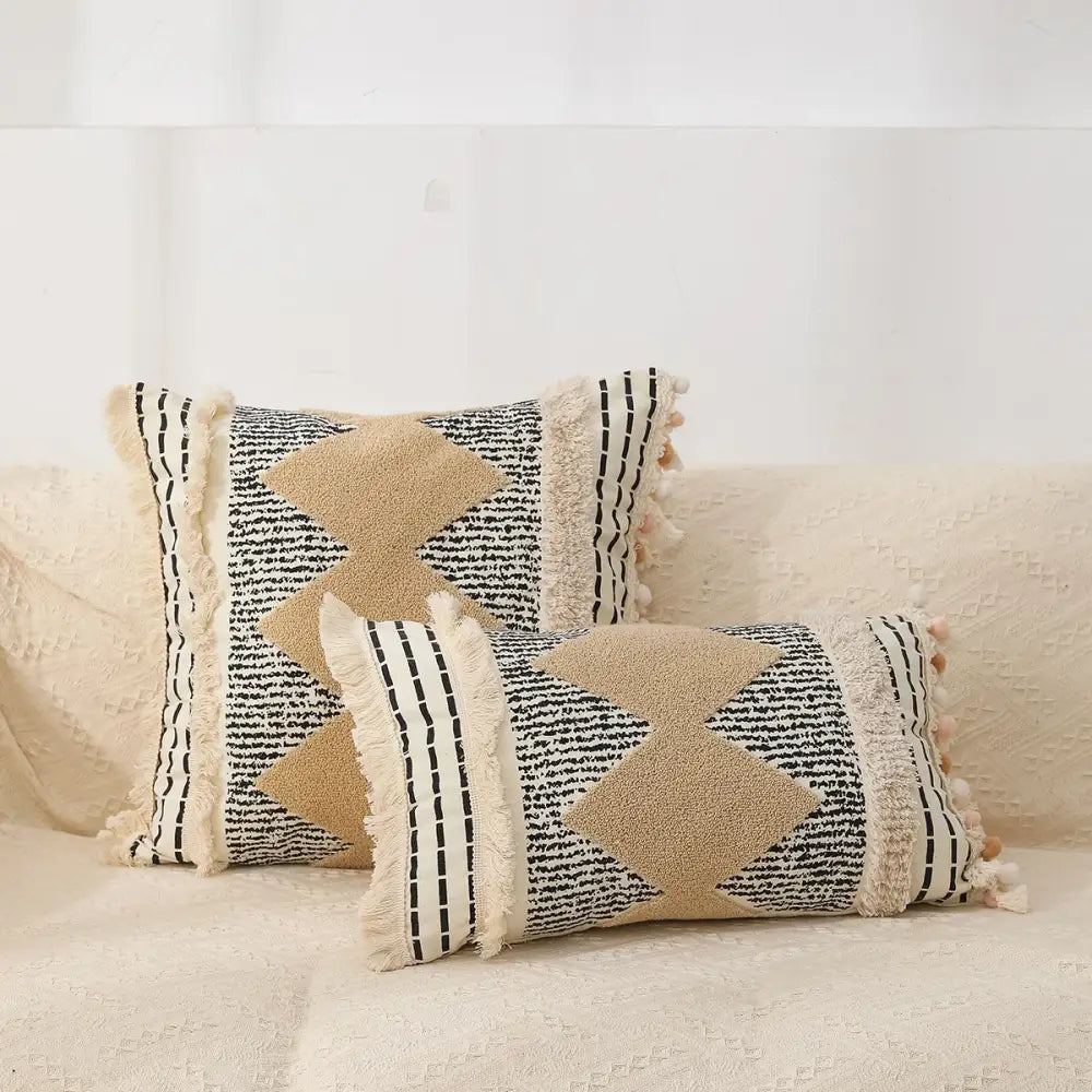 Beige and black woven pillow covers with textured star appliqués and fringed edges by decorbites geometric chenille