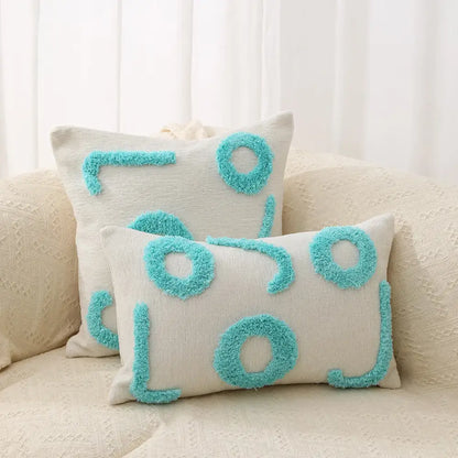 Cream-colored pillow covers with turquoise fuzzy geometric chenille embroidered patterns for living room decorbites