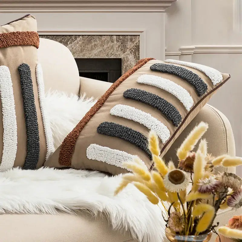 Beige cushion cover with gray and white textured horizontal stripes and brown border featuring decorbites geometric embroidery boho design