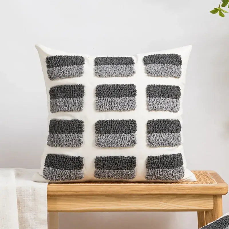 White throw cushion cover with decorbites geometric embroidery featuring chunky gray yarn tufts for boho decor