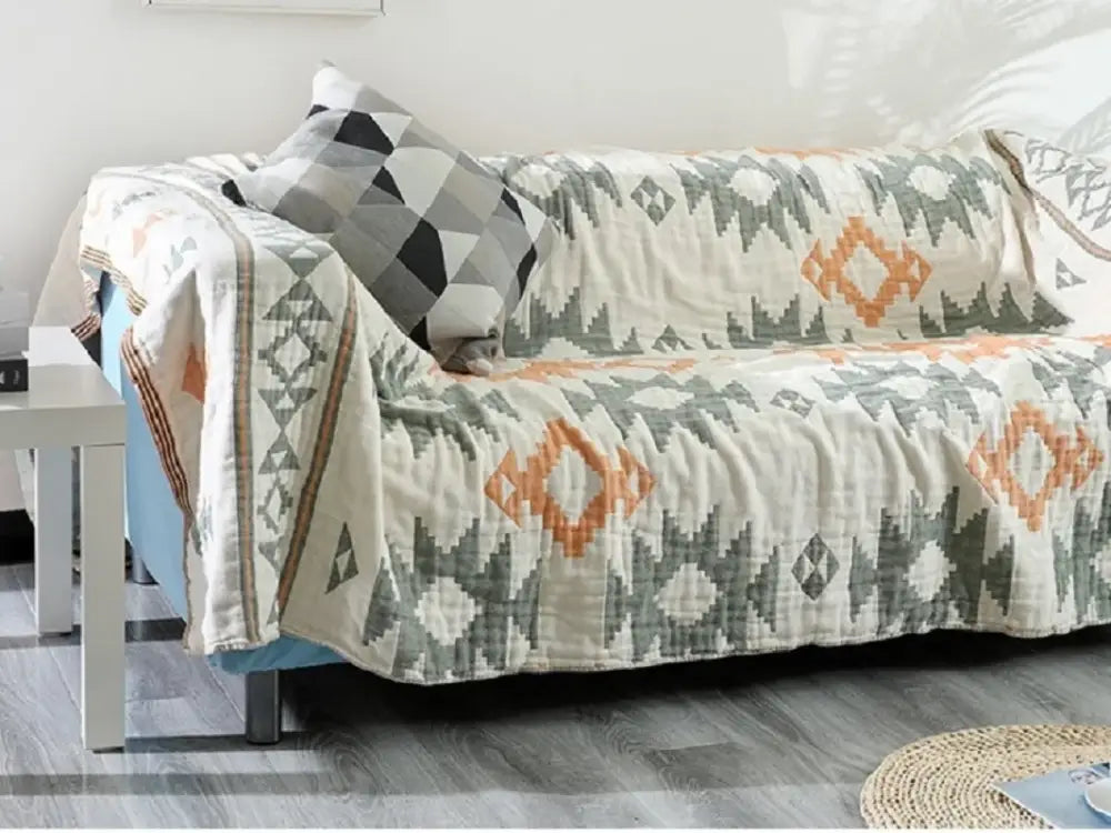 Beige gray and orange geometric patterned quilted sofa cover with textured fabric finish for boho cotton sofa decorbites throw blanket