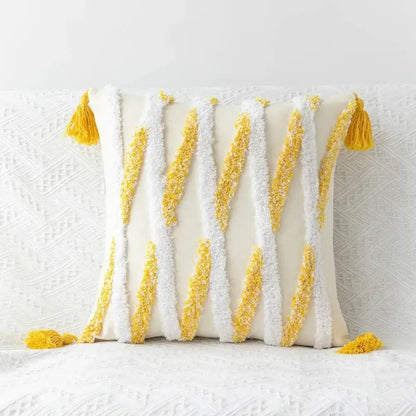 Cream-colored boho geometric tufted pillow cover with textured white and yellow tassels in diagonal stripes set of 4