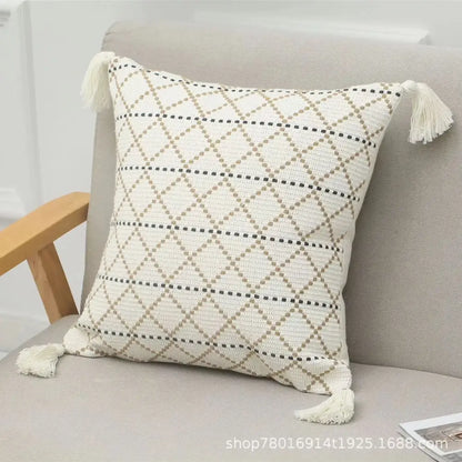 Cream-colored pillow cover with black and beige geometric diamond pattern and tassels from decorbites geometric tufted set