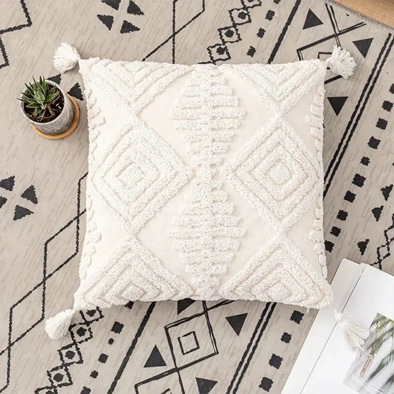 Cream-colored textured cushion cover with geometric embroidery ivory cotton loop decorbites ivory cotton tassels