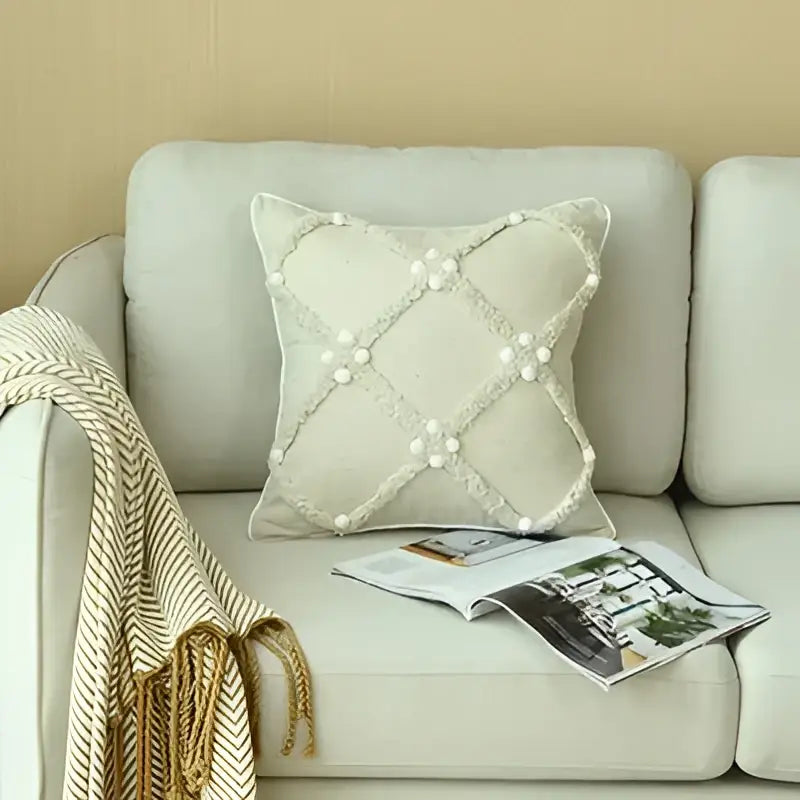 Beige boho ivory cushion cover with diamond pattern and pearl-like embellishments featuring colorful pompoms decorbites ivory boho