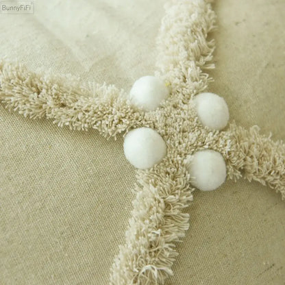 Cream-colored textured fringe trim with four white pom-poms on decorbites ivory boho cushion cover with colorful pompoms