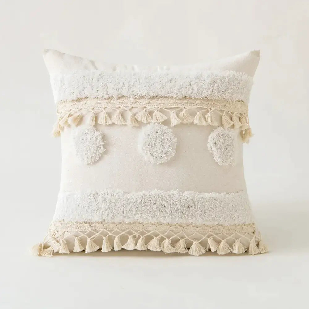Cream-colored boho ivory cushion cover with textured fabric, tassels, and fluffy pompoms for living room decorbites cushion cover