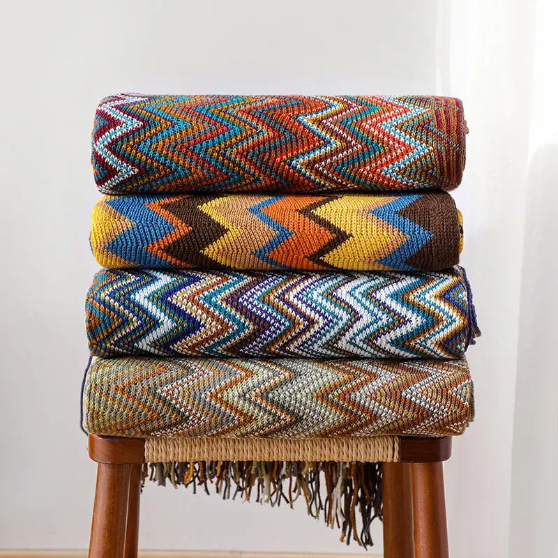 Stacked boho knitted striped blankets with vibrant zigzag patterns and fringe details for living room decorbites throw