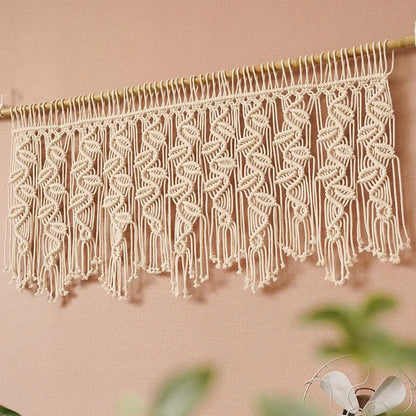 Cream-colored boho macrame tapestry curtain with intricate leaf pattern and dangling fringe for bedroom decorbites decor