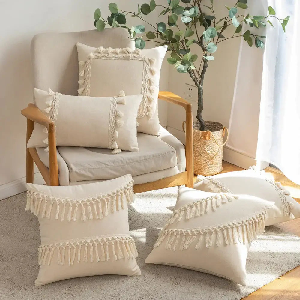 Cream-colored cotton boho macrame woven cushion cover with tassels and decorative macrame detailing by decorbites