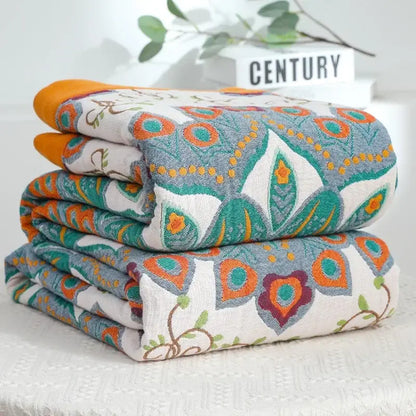 Stacked folded decorbites boho mandala cotton summer blankets with vibrant teal orange floral geometric patterns
