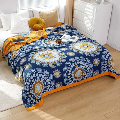 A cozy navy blue boho mandala cotton summer blanket with vibrant floral pattern and orange border for bedroom decor