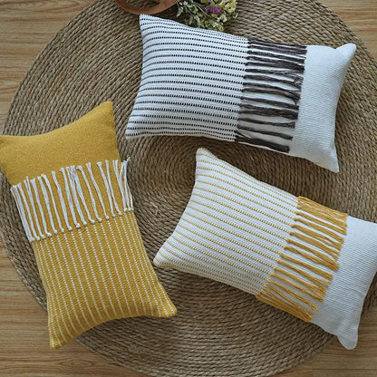 Three rectangular woven boho moroccan fringed pillowcases in mustard yellow black and white for earthy tones decorbites living room