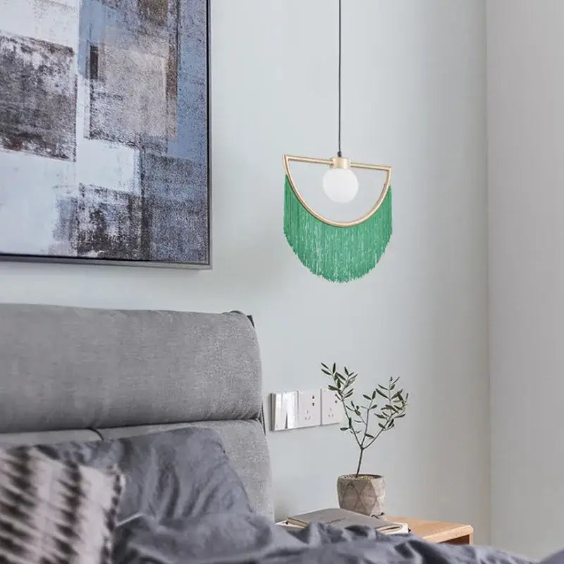 Boho multi color fringe glass ball pendant light with green fringe and gold semi circular frame for bedroom use