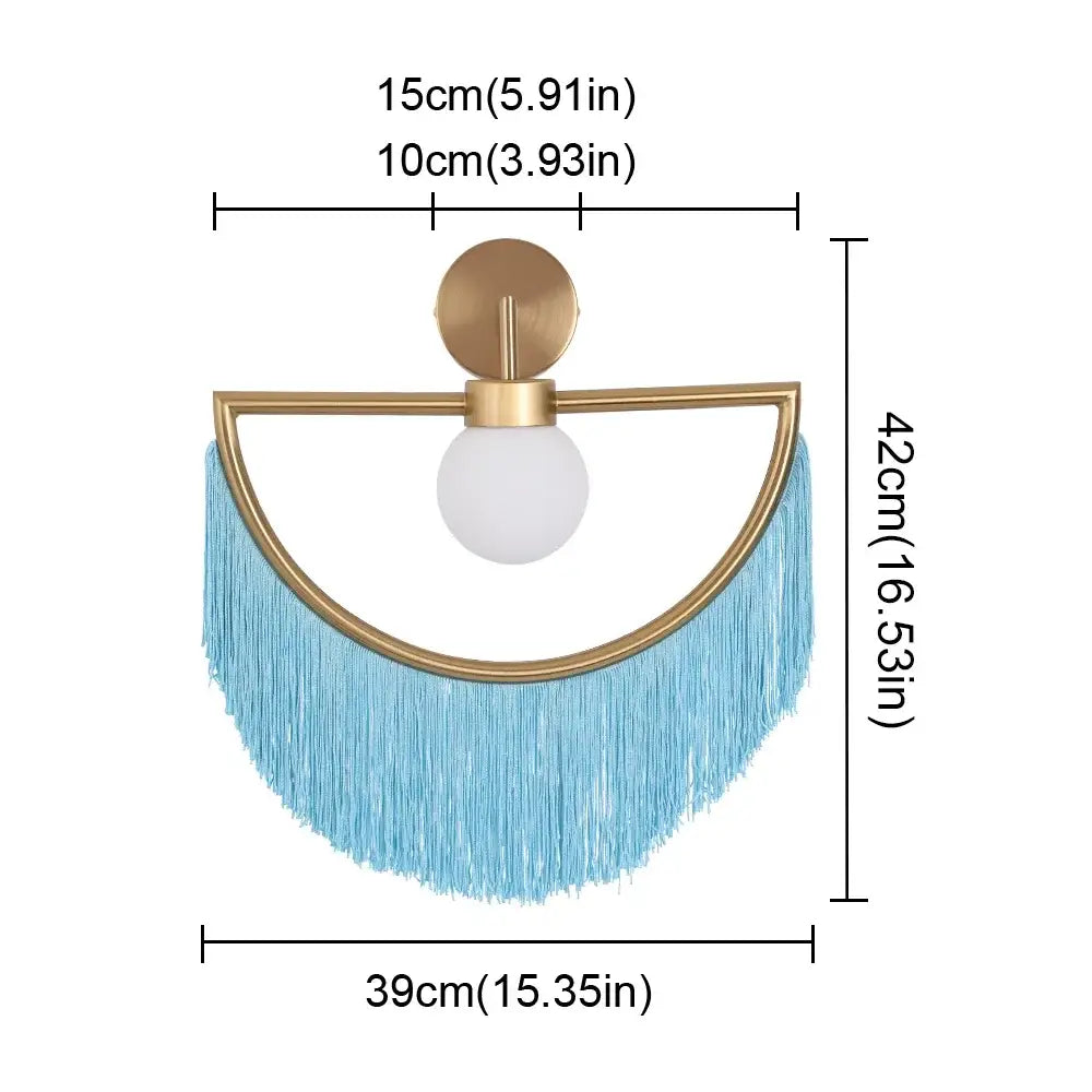 A modern gold-toned ball pendant light with a white glass ball and light blue fringe for bedroom use