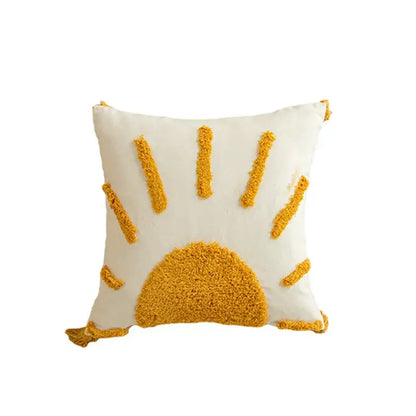 Cream-colored cushion cover with textured mustard-yellow geometric tufted embroidered sun design and pom pom trim decorbites
