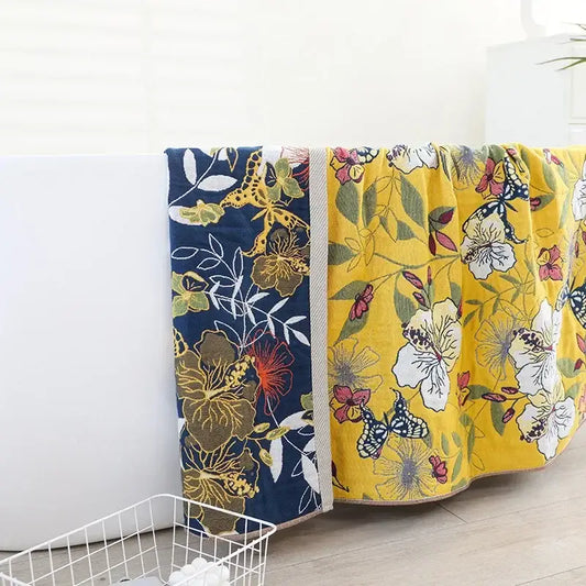 Two patterned boho navy and yellow cotton bath towels with floral and giraffe motifs ideal for bathroom decorbites cotton bath use
