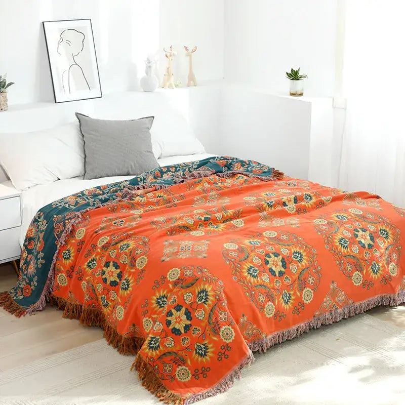 Vibrant orange decorbites gauze boho towel blanket with teal yellow cream floral patterns and fringed edge muslin throw