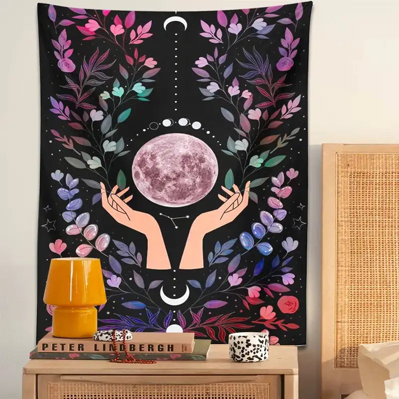 A vibrant black boho pink botanical moon tapestry with a central pink moon and colorful floral and celestial motifs