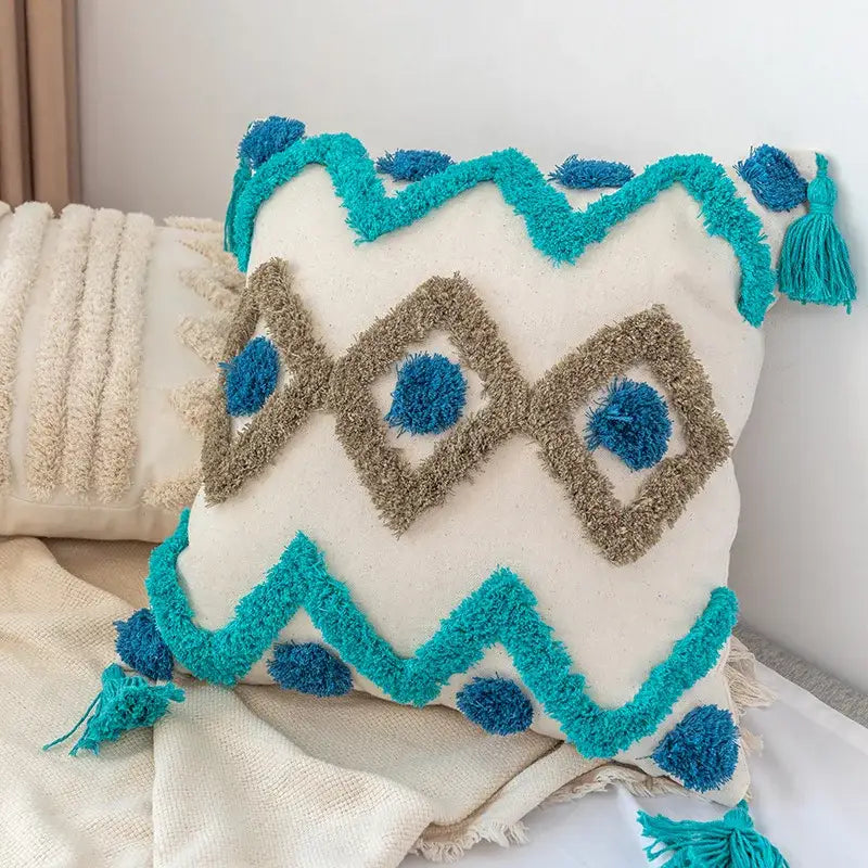 Cream-colored decorbites boho square pillowcase with turquoise embroidery blue pom-poms and teal tassels for living room decor
